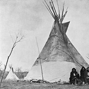 COMANCHES, c1880. A group of four Comanche people seated in front of a tipi