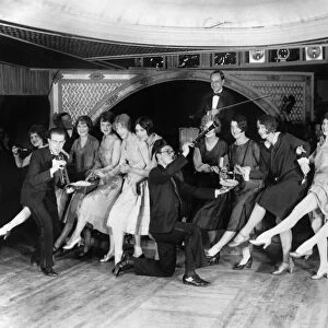 Contestants at a Charleston dance contest being served food by musicians at a nightclub in New York City, c1926