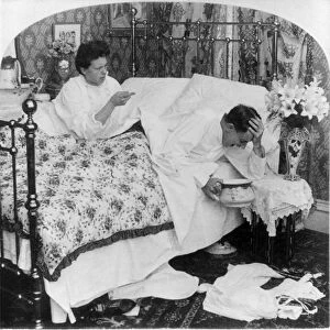 COUPLE IN BED, c1907. A woman talking to her husband, who holds his head over a bedpan