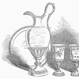 DECORATIVE SERVICE, 1852. Decorative service of silver plate presented to George Steers, an American shipbuilder, December 1851. Contemporary American wood engraving