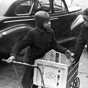 DELIVERY BOYS, 1941. Delivery boys waiting in front of the A&P supermarket for
