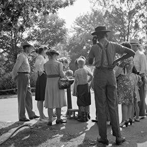 DETROIT, 1942. People waiting to drink from a water fountain at the zoo in Detroit, Michigan