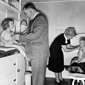 A doctor and nurse examining children in a trailer clinic at a mobile camp for migrant workers in Klamath County, Oregon. Photograph by Dorothea Lange, October 1939