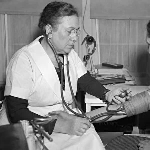 DOCTOR AND PATIENT, 1938. Dr. Kate B. Karpeles, president of the American Medical