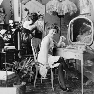 DRESSING ROOM, c1900. Two women wearing undergarments in a dressing room