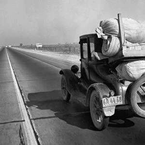 DROUGHT REFUGEE, 1936. Drought refugees traveling on U. S. Highway 99 between Bakersfield and Famoso, California. Photograph by Dorothea Lange, 1936