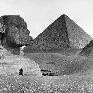 EGYPT: SPHINX AND PYRAMID. A view of the Great Sphinx at Giza, Egypt, partially excavated