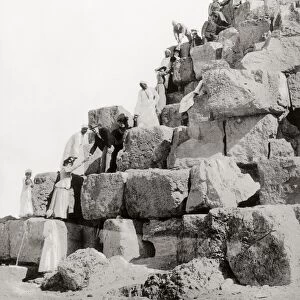 EGYPT: TOURISM, c1890s. European ladies ascending a pyramid at Giza with the help of their escorts and Egyptian guides. Photograph, c1890s