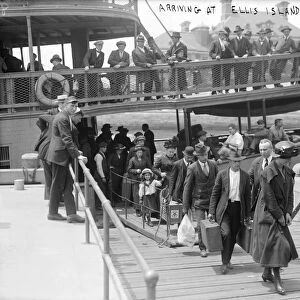 ELLIS ISLAND, c1900. Women and children arriving at Ellis Island with their belongings