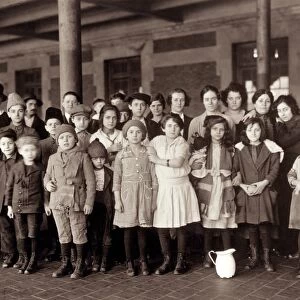 ELLIS ISLAND, c1908. A group of immigrant women and children at Ellis Island. Photograph