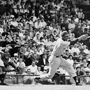 ERNIE BANKS (1931- ). American baseball player. As a member of the Chicago Cubs, batting against the Brooklyn Dodgers in a game at Ebbets Field in Brooklyn, New York, August 1955. The Dodgers catcher is Roy Campanella