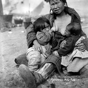 ESKIMO MOTHER AND BABIES. An Inuit mother breast-feeding her two babies, North America