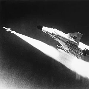 F-4 Phantom II fighter aircraft firing a missile, 1966