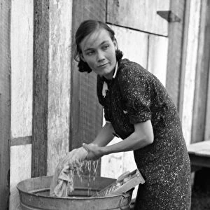 FARMERs WIFE, 1938. A farmers wife washing clothes in a washbin, near Morganza, Louisiana