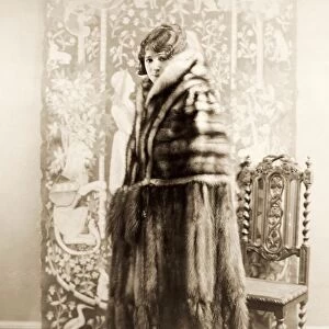 FASHION: FUR, 1925. American actress Helen Ferguson wearing a heavy cape of stone marten