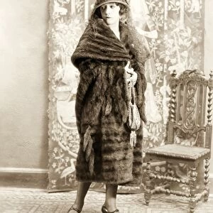FASHION: FUR, 1925. American actress Helen Ferguson wearing a mink dolman trimmed with tails