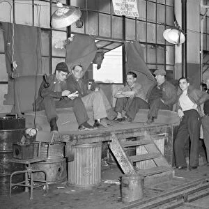 FLINT SIT DOWN STRIKE, 1937. Strikers guarding the entrance to the Fisher body plant #3 in Flint