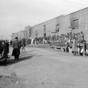 FLOOD REFUGEES, 1937. People waiting in a food line at a flood refugee camp in Forrest City