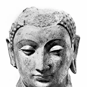 Fragment of a stucco with polychrome head of Buddha, 4th-7th century, from the Rawak stupa (sacred burial place) in the Taklamakan desert, Chinese Turkestan. Height: 7. 25 inches