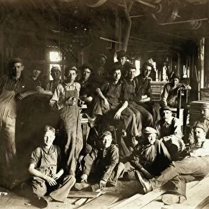 FURNITURE FACTORY, 1908. A group of men and boys during their rest period in a