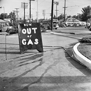 GAS STATION, 1942. Sign announcing Now Out of Gas, placed outside a gas station