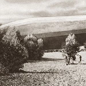German Zeppelin airship lying helpless in a field near Bourbonne-les-Bains, France, during World War I. Photograph, c1916