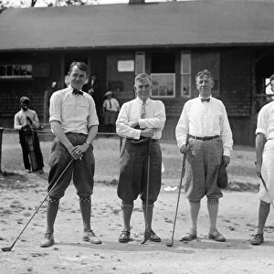 GOLF: MEN, 1924. Men wearing golf clothing and holding golf clubs. Photograph, 1924