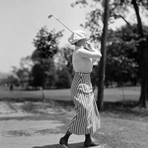 GOLFING, 1916. Miss Edith Gordon playing golf. Photograph, 1916