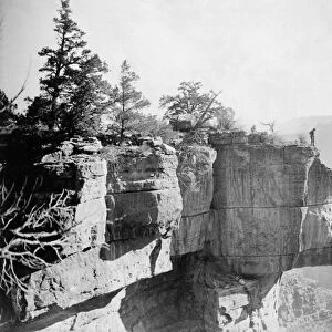 GRAND CANYON, c1906. A man standing on the ledge of a limestone cliff overlooking