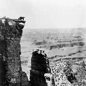 GRAND CANYON, c1907. A woman on the edge of Grand View Point overlooking the Grand
