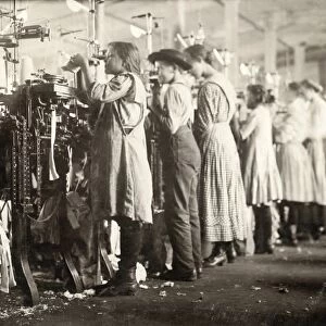 A group of young knitters working at the textile machines at the Loudon Hosiery Mill in Loudon, Tennessee. Photograph by Lewis Hine, December 1910