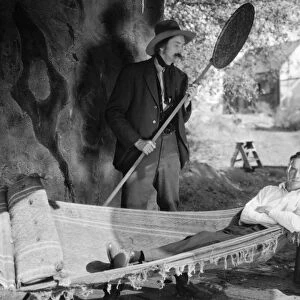 HAMMOCK, 1925. Director William K. Howard tries out a hammock on the set of the film The Light of the Western Star, 1925