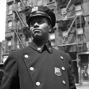 HARLEM: POLICEMAN, 1943. A policeman from Harlem, New York. Photograph by Gordon Parks