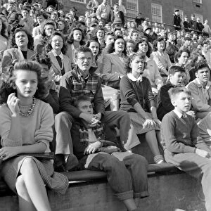 HIGH SCHOOL, 1943. High schoolers watching the football game at Woodrow Wilson