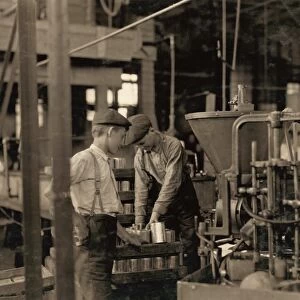 HINE: CHILD LABOR, 1909. Young workers using a dangerous canning machine at the J