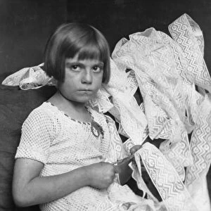 HINE: CHILD LABOR, 1924. A young girl cutting lace at her home in New York City