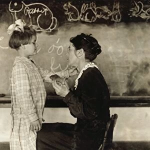 HINE: CLASSROOM, 1917. Teaching a deaf-mute how to talk at the Training School