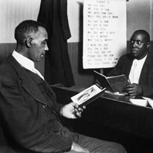 HINE: EDUCATION, 1920. Three African-American men reading and writing, somewhere