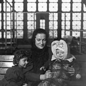 HINE: ELLIS ISLAND. An Italian mother with her children at Ellis Island. Photograph by Lewis W