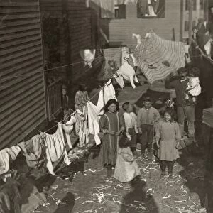 HINE: MILL HOUSING, 1912. Textile mill workers family in the yard with a clothesline