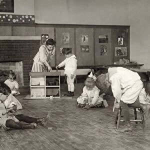 HINE: KINDERGARTEN, 1917. Children making wooden doll house pieces in a kindergarten