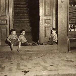 HINE: STREET BOYS, 1909. Three boys hanging out in a doorway late at night in Boston