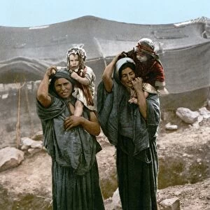 HOLY LAND: BEDOUINS, c1895. Two Bedouin women holding young children outside a tent