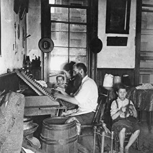 HOME INDUSTRY, 1890. A family of Bohemian cigarmakers at work in their tenement