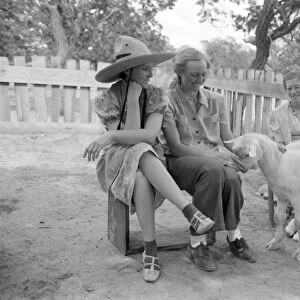 HOMESTEADERS, 1940. A group of women with a goat in Pie Town, New Mexico