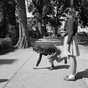 HOPSCOTCH, 1942. A Chinese-American girl playing hopscotch with her Jewish friend