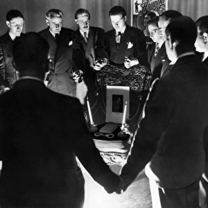 HOUDINI SEANCE, 1936. A group of magicians conducting a seance in Detroit, Michigan