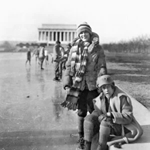 ICE SKATERS. Two women identified as Celene DuPuy and Abbey Jackson (seated) wearing ice skates