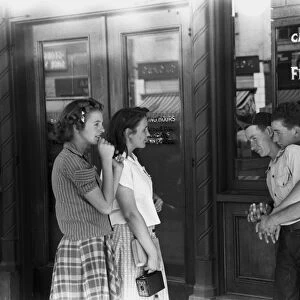 IDAHO: FLIRTING, 1941. Teenage girls and boys flirting with each other in front