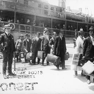IMMIGRANTS, 1920. European immigrants leaving the Ellis Island ferry to arive in